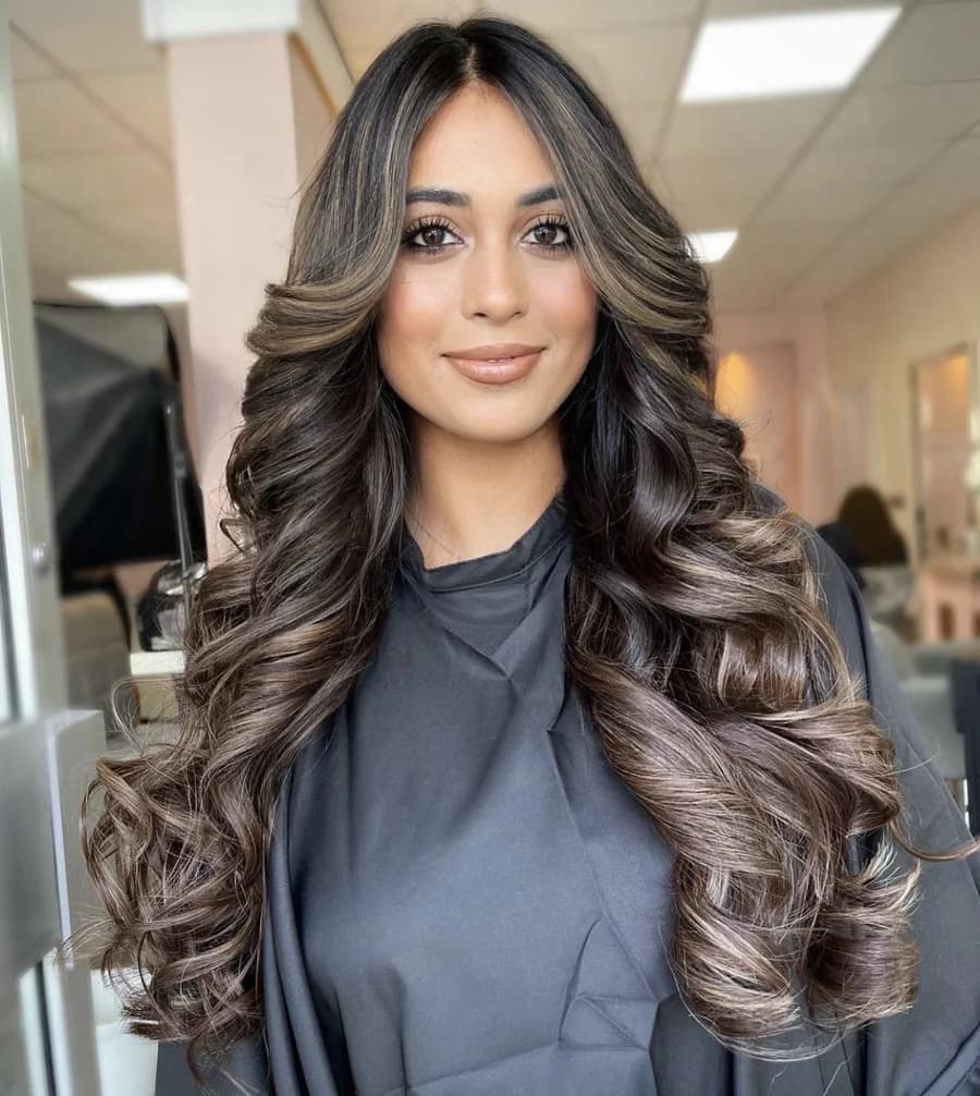 Bouncy blow-dry curls with a deep side parting and face-framing sweep