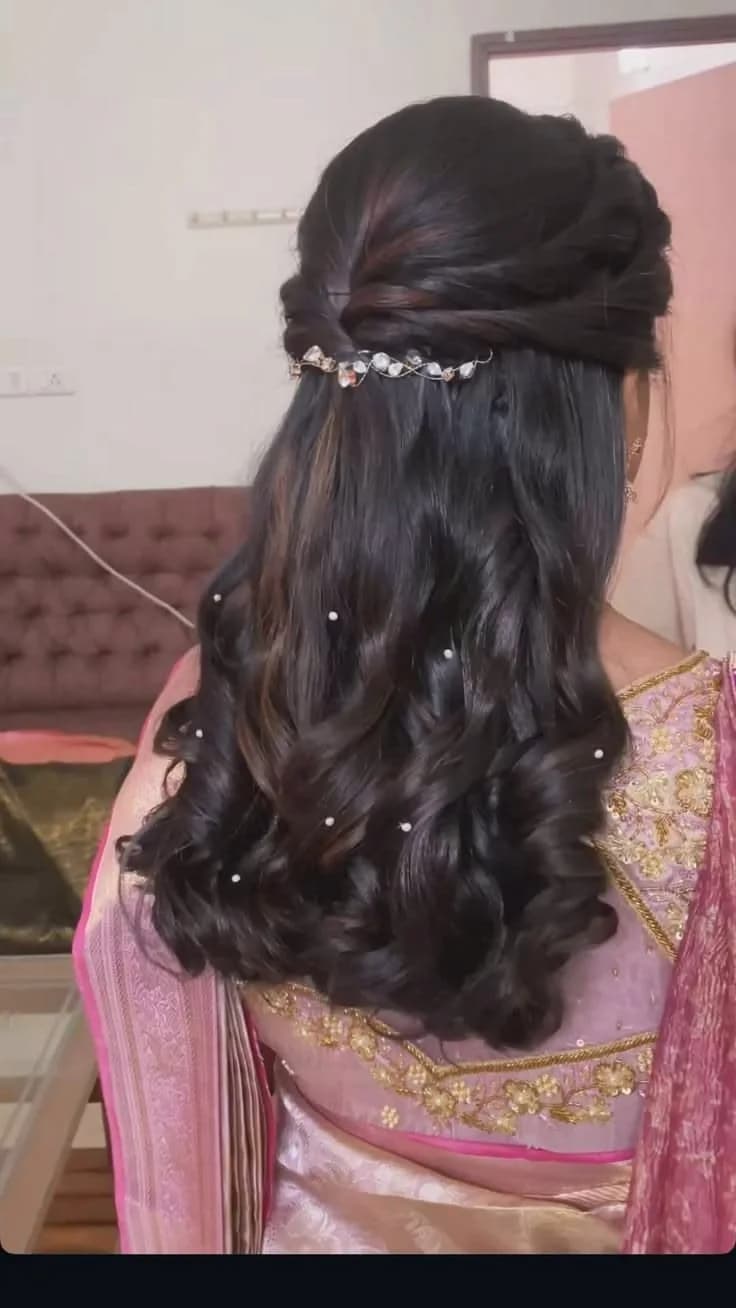 Half-up style with a jewelled headpiece and pearl pins set through soft curls