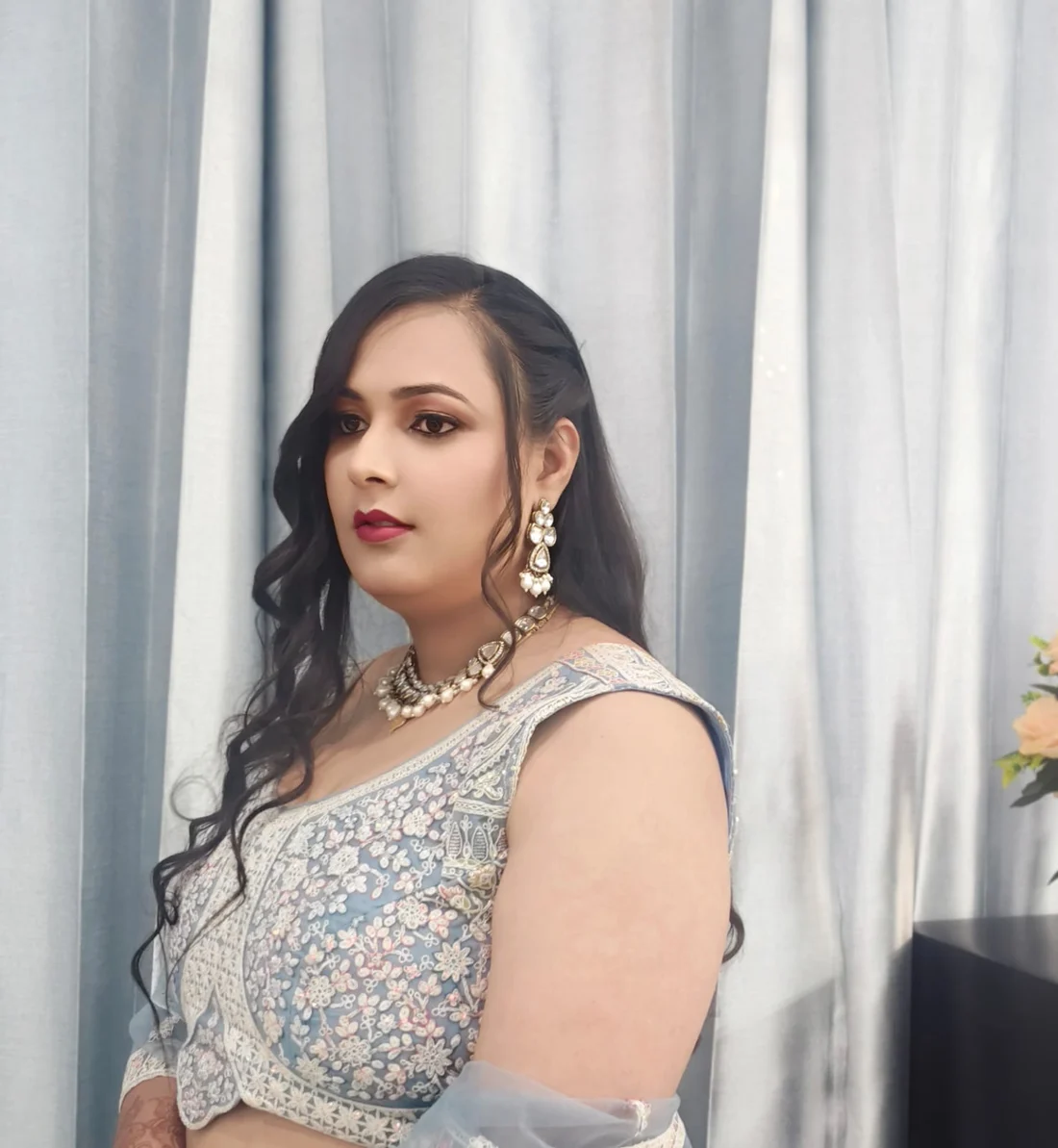 Occasion makeup with a bronze smoky eye and berry lip, worn with a powder-blue lehenga