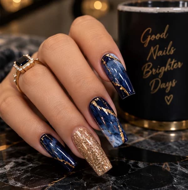 Navy marble coffin nails with gold foil veining and a gold glitter accent nail