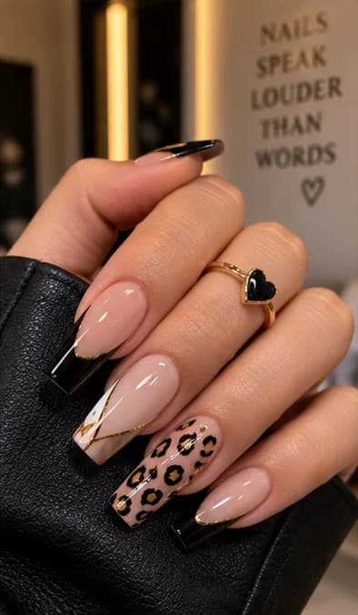 Nude coffin nails with black tips, gold veining and a leopard-print accent nail