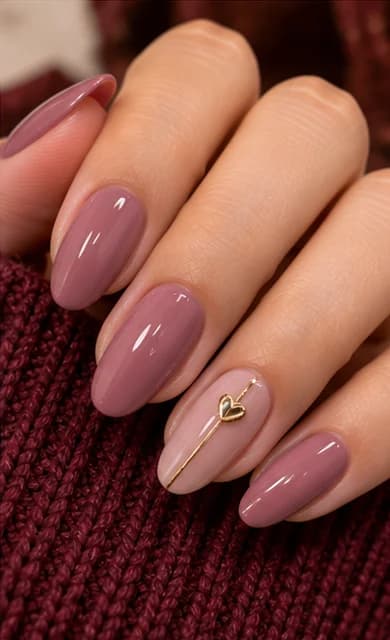 Mauve almond gel nails with a fine gold heart outline on the accent nail
