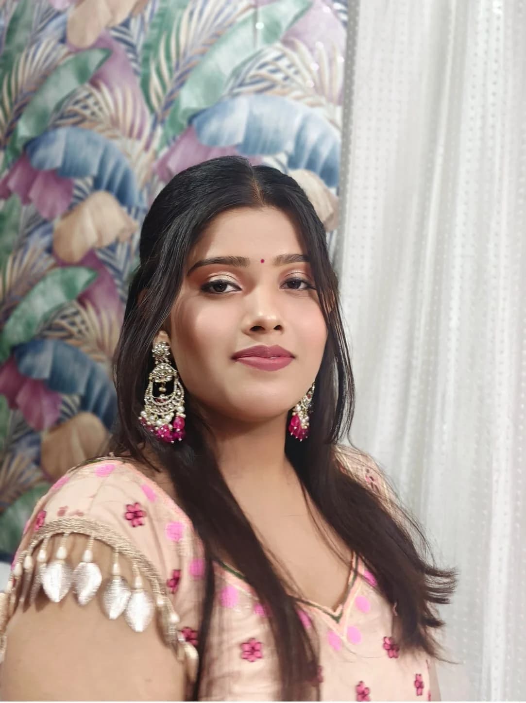 Soft party makeup with a rose lip and a warm shimmer eye, worn with a blush floral outfit
