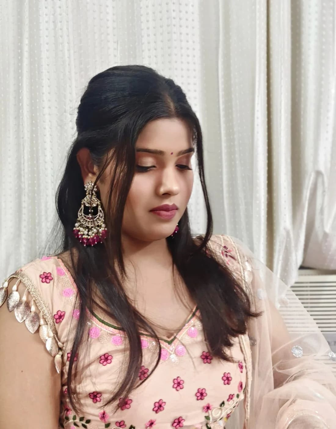 Occasion makeup with a soft bronze eye and a half-up set, worn with a blush embroidered outfit
