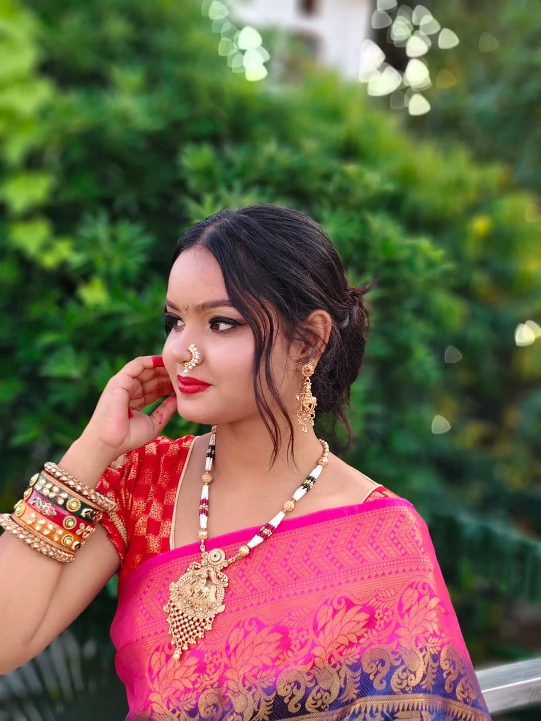 Traditional occasion look with a nath and gold jewellery, worn with a pink silk saree