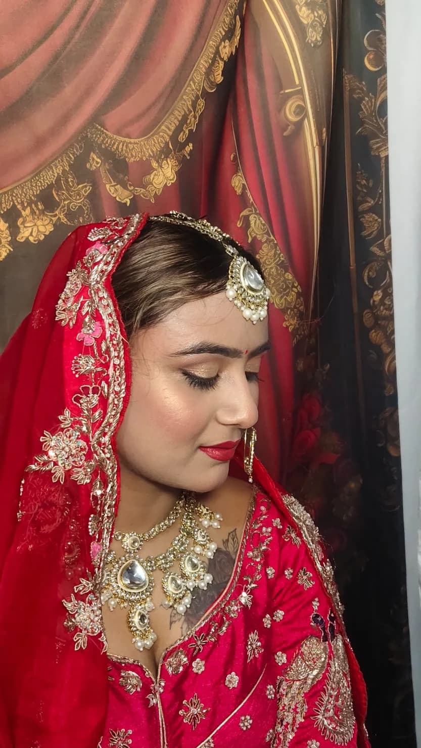 Red bridal look with a gold shimmer eye and heavy kundan jewellery